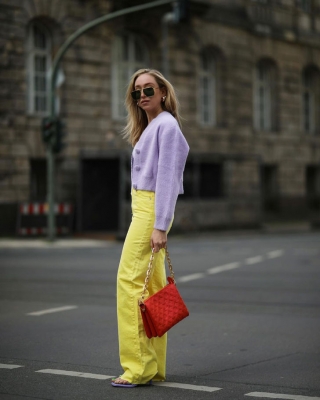 Девушка в широких желтых брюках и светло фиолетовом кардигане